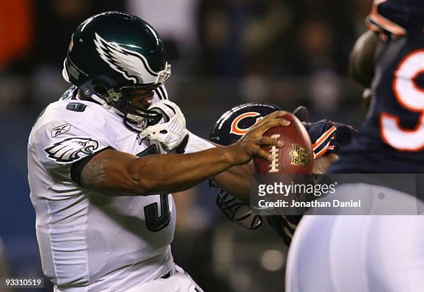 Quarterback Donovan McNabb#5 of the Philadelphia Eagles has his facemask grabbed by Israel Idonije of the Chicago Bears in the first quarter at...