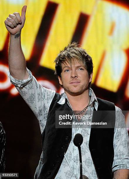 Musician Joe Don Rooney of Rascal Flatts accepts Winner of Country - Favorite Band, Duo or Group Award onstage at the 2009 American Music Awards at...