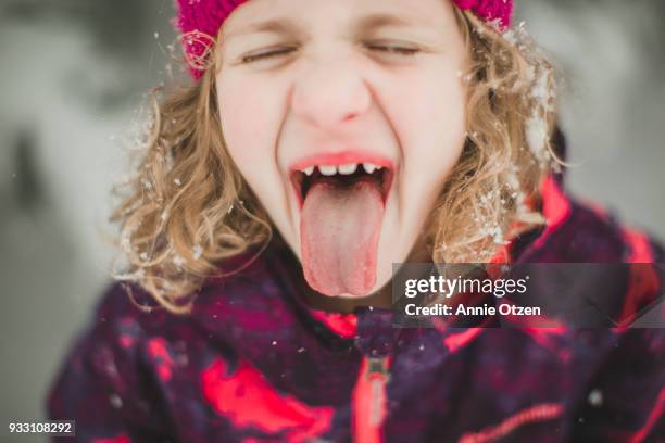 Little Girl trying to catch snowflakes