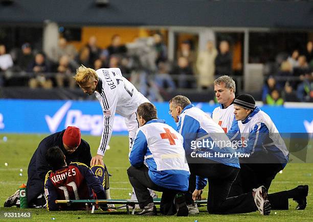 David Beckham of the Los Angeles Galaxy speaks with Javier Morales of Real Salt Lake as he is attended to by medical staff during the MLS Cup final...