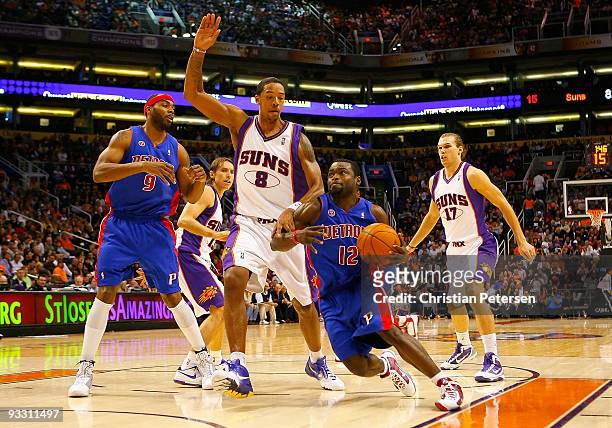 Will Bynum of the Detroit Pistons drives the ball past Channing Frye of the Phoenix Suns during the NBA game at US Airways Center on November 22,...