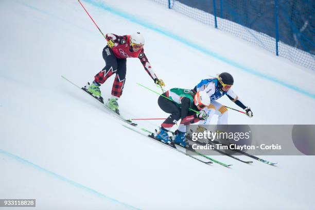 Marielle Thompson from Canada about to fall as she crosses her skis on landing while competing against Talina Gantenbein of Switzerland and Lisa...