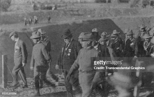 American politician US President William Howard Taft walks with dignitaries and law enforcement officers during the opening of the Gunnison...