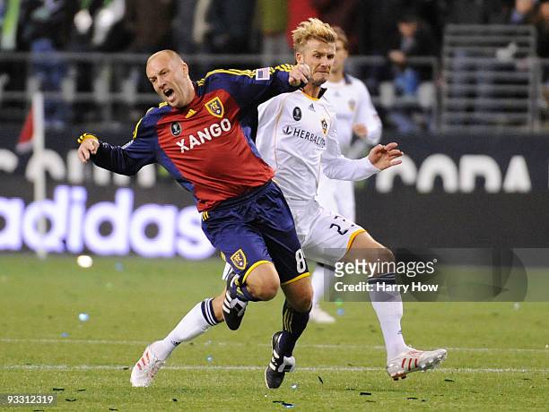 David Beckham of Los Angeles Galaxy commits a foul against Clint Mathis of Real Salt Lake during the MLS Cup final at Qwest Field on November 22,...
