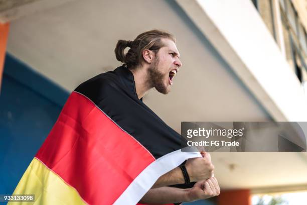 german fan watching a soccer game - soccer germany stock pictures, royalty-free photos & images