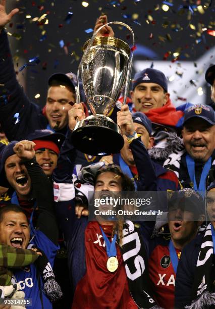 Kyle Beckerman of Real Salt Lake holds the Philip F. Anschutz MLS Cup trophy as he and his teammates celebrate their win over the Los Angeles Galaxy...