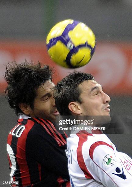 Milan's forward Marco Borriello fights for the ball with Cagliari's defender Davide Astori during their Italian Serie A football match on November...