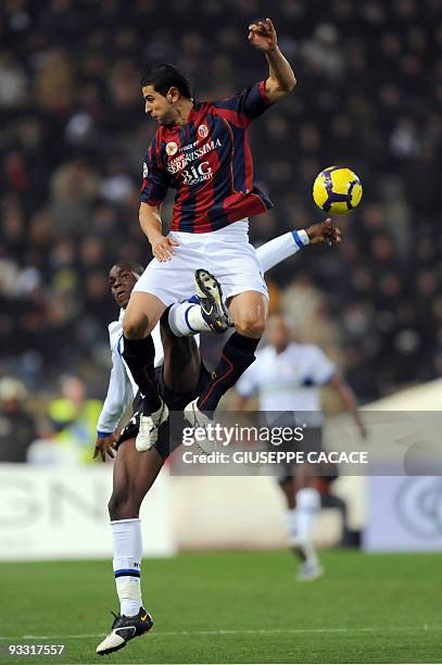 Inter Milan's forward Mario Balotelli fights for the ball with Bologna's defender Miguel Angel Britos of Uruguay during their Serie A football match...