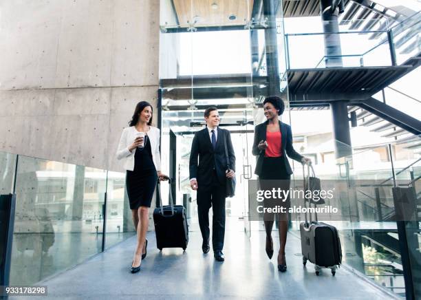 latin executives walking with suitcases and hand luggage - business journey stock pictures, royalty-free photos & images