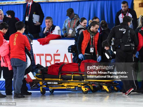 Tianyu Han of China is placed on a stretcher after crashing hard into the padding in the men's 1500 meter B Final during the World Short Track Speed...