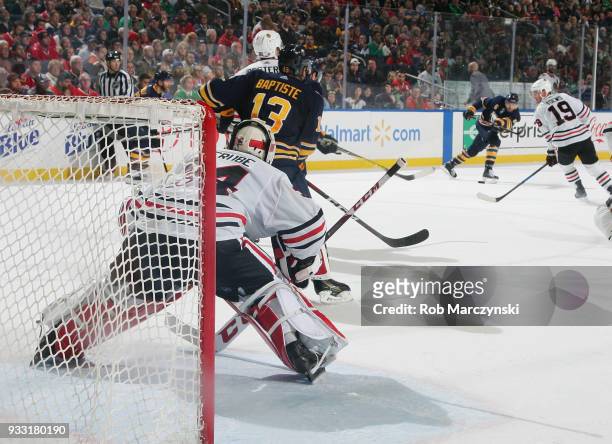 Nicholas Baptiste of the Buffalo Sabres looks to deflect a shot by Marco Scandella for a goal against J-F Berube of the Chicago Blackhawks during an...