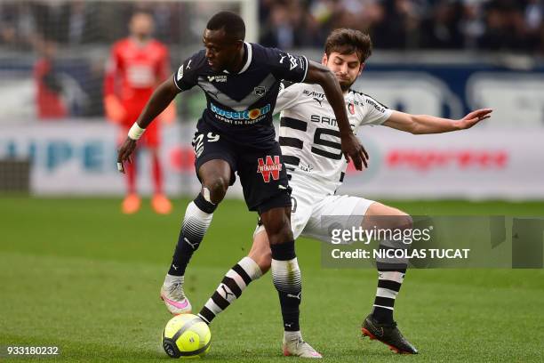 Bordeaux's French defender Maxime Poundje vies with Rennes' French midfielder Sanjin Prcic during the French L1 football match between Bordeaux and...