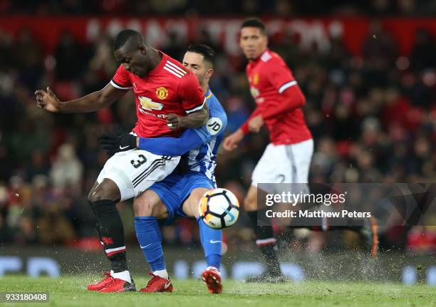 Eric Bailly of Manchester United in action with Beram Kayal of Brighton & Hove Albion during the Emirates FA Cup Quarter Final match between...