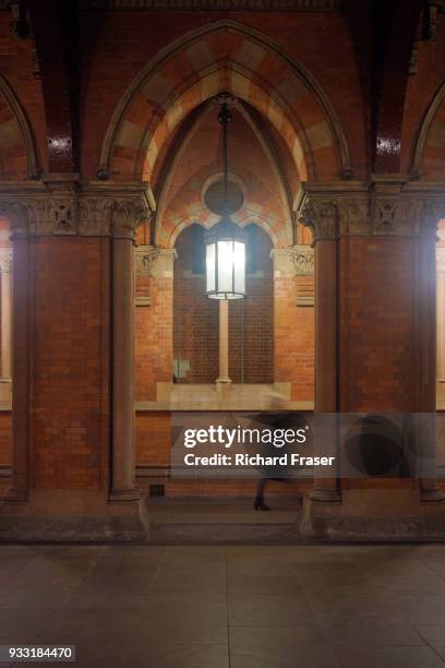 a woman walking through an archway - january 2018 stock pictures, royalty-free photos & images