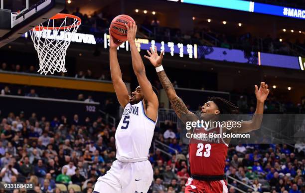 Phil Booth of the Villanova Wildcats goes to the basket for a slam dunk against John Petty of the Alabama Crimson Tide in the second half during the...