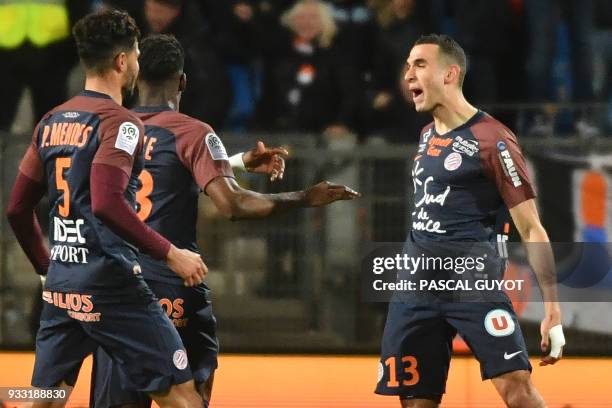 Montpellier's French midfielder Ellyes Skhiri celebrates with teammates after scoring a goal during the French L1 football match between MHSC...