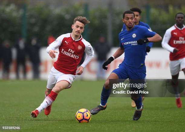 Vlad Dragomir of Arsenal takes on Josh Grant of Chelsea during the match between Arsenal U23 and Chelsea U23 at London Colney on March 17, 2018 in St...