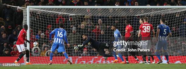 Sergio Romero of Manchester United makes a save from Lewis Dunk of Brighton & Hove Albion during the Emirates FA Cup Quarter Final match between...