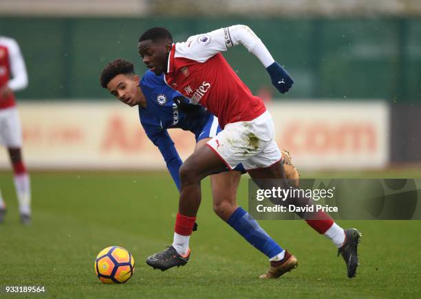 Josh Dasilva of Arsenal takes on Jacob Maddox of Chelsea during the match between Arsenal U23 and Chelsea U23 at London Colney on March 17, 2018 in...