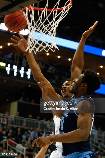 Javin DeLaurier of the Duke Blue Devils shoots the ball against Cyril Langevine of the Rhode Island Rams during the second half in the second round...