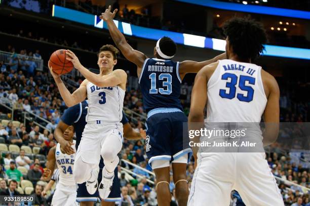 Grayson Allen of the Duke Blue Devils passes the ball to Marvin Bagley III against Stanford Robinson of the Rhode Island Rams during the second half...