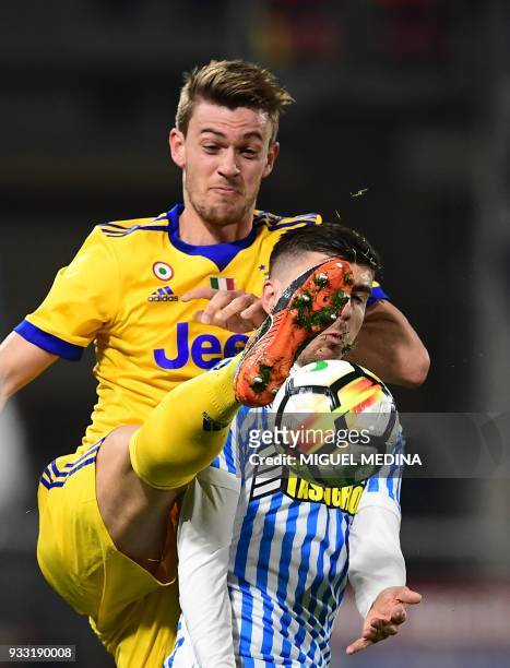 Juventus' Italian defender Daniele Rugani vies with Spal's Italian forward Alberto Paloschi during the Italian Serie A football match Spal vs...