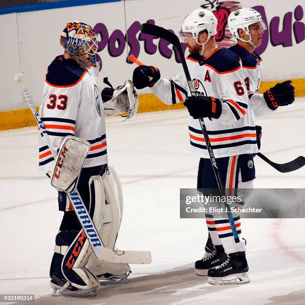 Goaltender Cam Talbot of the Edmonton Oilers celebrates their 4-2 with teammate Adam Larsson against the Florida Panthers at the BB&T Center on March...