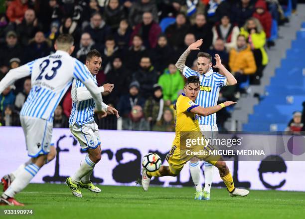 Juventus' Argentinian forward Paulo Dybala vies with Spal's Polish defender Thiago Cionek, Spal's defender Francesco Vicari and Spal's midfielder...