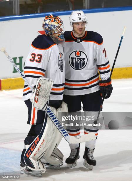 Goaltender Cam Talbot is congratulated by Oscar Klefbom of the Edmonton Oilers after the game against the Florida Panthers at the BB&T Center on...