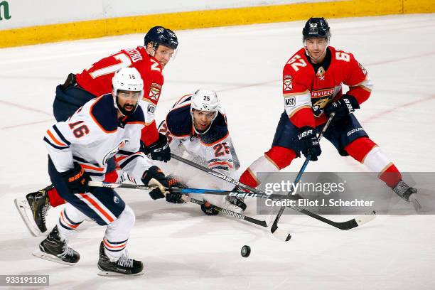 Jujhar Khaira and Darnell Nurse of the Edmonton Oilers tangles with Nick Bjugstad and Denis Malgin of the Florida Panthers at the BB&T Center on...