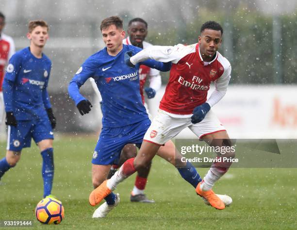 Joe Willock of Arsenal takes on Charlie Colkett of Chelsea during the match between Arsenal U23 and Chelsea U23 at London Colney on March 17, 2018 in...