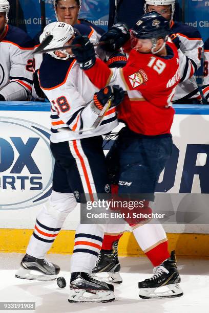 Anton Slepyshev of the Edmonton Oilers tangles with Michael Matheson of the Florida Panthers at the BB&T Center on March 17, 2018 in Sunrise, Florida.