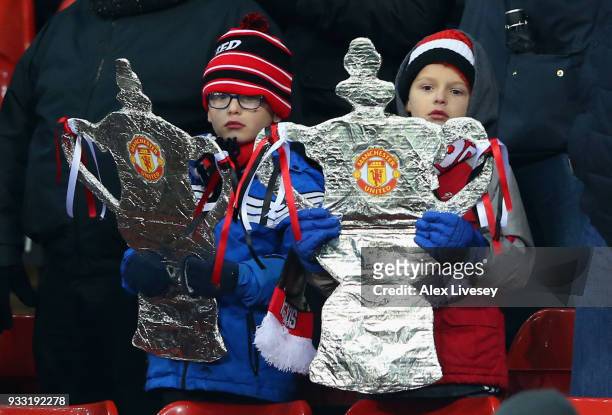 Two young Manchester United fans with their home made FA Cup's during the Emirates FA Cup Quarter Final between Manchester United and Brighton & Hove...