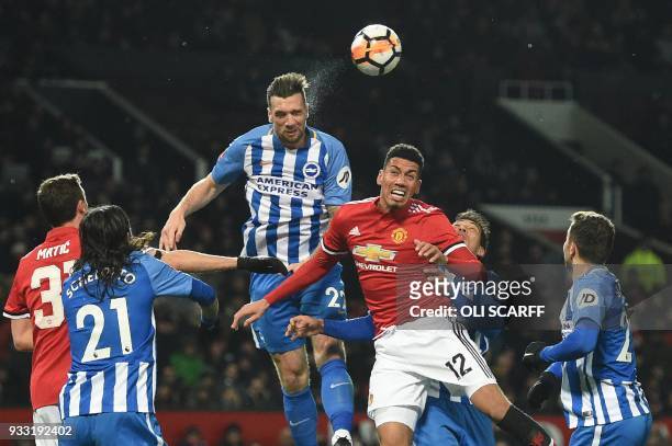 Brighton Irish defender Shane Duffy vies with Manchester United's English defender Chris Smalling during the English FA Cup quarter-final football...
