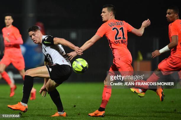 Angers' French forward Baptiste Guillaume vies with Caen's French defender Frederic Guilbert during the French L1 Football match between Angers and...