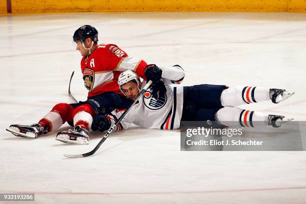 Aleksander Barkov of the Florida Panthers collides with Ty Rattie of the Edmonton Oilers at the BB&T Center on March 17, 2018 in Sunrise, Florida.