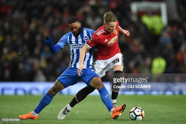 Brighton's Dutch striker Jurgen Locadia tackles Manchester United's English midfielder Scott McTominay during the English FA Cup quarter-final...