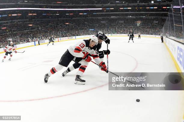 Torrey Mitchell of the Los Angeles Kings battles for the puck against Nico Hischier of the New Jersey Devils at STAPLES Center on March 17, 2018 in...