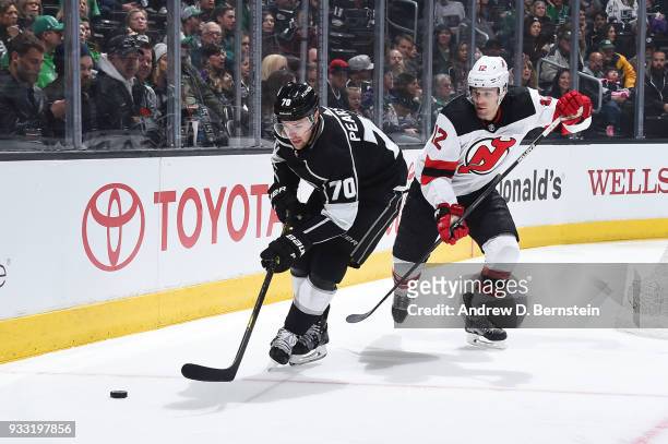 Tanner Pearson of the Los Angeles Kings handles the puck against Ben Lovejoy of the New Jersey Devils at STAPLES Center on March 17, 2018 in Los...