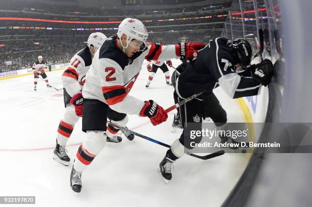 John Moore of the New Jersey Devils battles for the puck against Torrey Mitchell of the Los Angeles Kings at STAPLES Center on March 17, 2018 in Los...