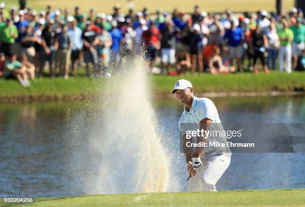 Tiger Woods plays a shot from a bunker on the 17th hole during the third round at the Arnold Palmer Invitational Presented By MasterCard at Bay Hill...