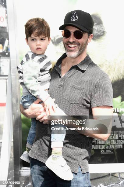 Actor Reid Scott and his son Conrad Scott arrive at the premiere of Warner Bros. Pictures and IMAX Entertainment's "Pandas" at the TCL Chinese...