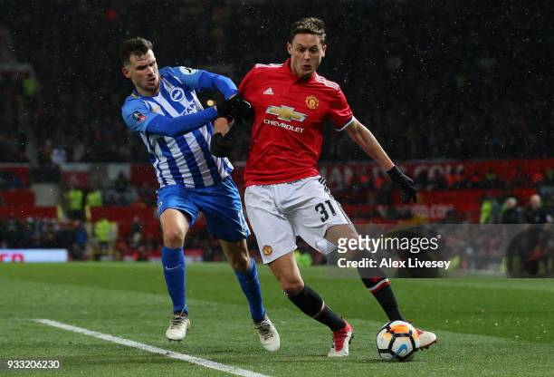 Nemanja Matic of Manchester United is challenged by Pascal Gross during the Emirates FA Cup Quarter Final between Manchester United and Brighton &...