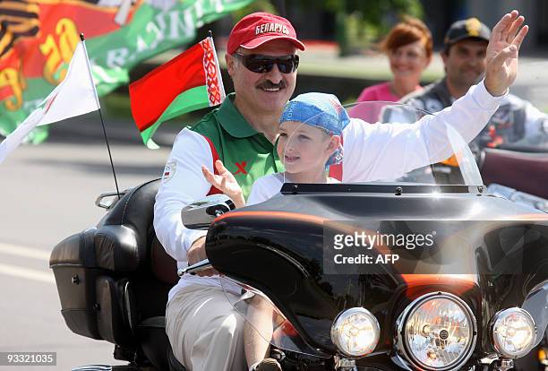 Amelie HERENSTEIN Picture taken on July 18, 2009 shows Belarussian President Alexander Lukashenko riding a Harley-Davidson motorcycle with his son...