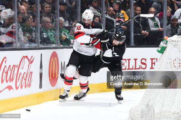 Drew Stafford of the New Jersey Devils battles for the puck against Nate Thompson of the Los Angeles Kings at STAPLES Center on March 17, 2018 in Los...