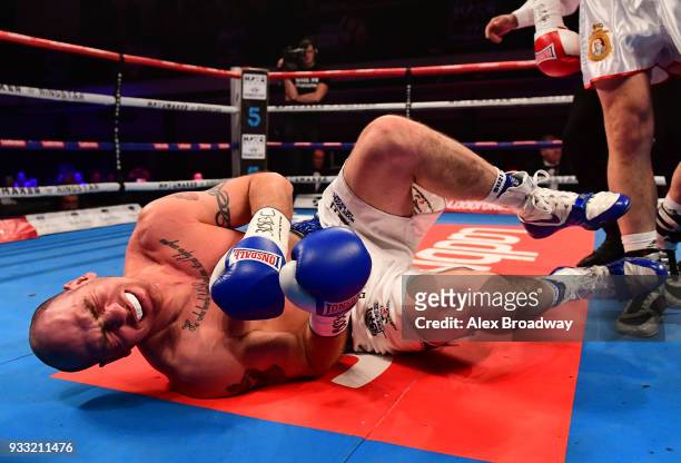 Stephen Simmons is knocked down by Matty Askin during their British Crusierweight Title fight at York Hall on March 17, 2018 in London, England.