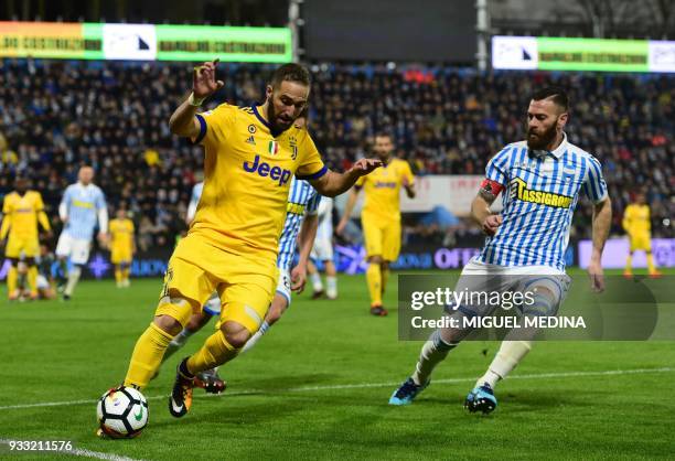 Juventus' Argentinian forward Gonzalo Gerardo Higuain vies with Spal's captain Italian forward Mirco Antenucci during the Italian Serie A football...