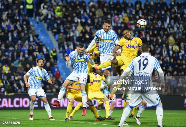 Juventu's Brazilian forward Douglas Costa fights for the ball with Spal's Italian forward Alberto Paloschi during the Italian Serie A football match...