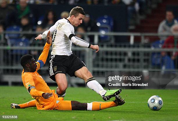 Lukas Podolski of Germany battles for the ball with Kolo Toure of Ivory Coast during the International Friendly match between Germany and Ivory Coast...