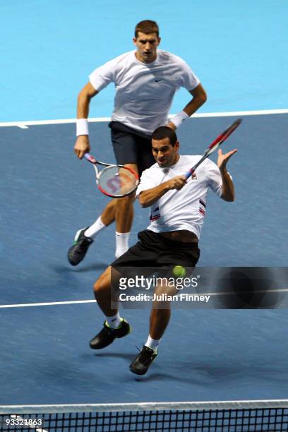 Max Mirnyi of Belarus plays with Andy Ram of Israel during the men's doubles first round match against Bob Bryan of USA and Mike Bryan of USA during...